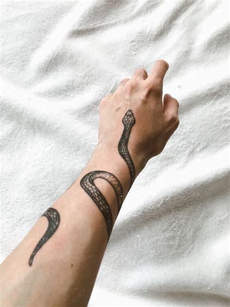 snake tattoos wrapped around arm|small snake tattoo designs.